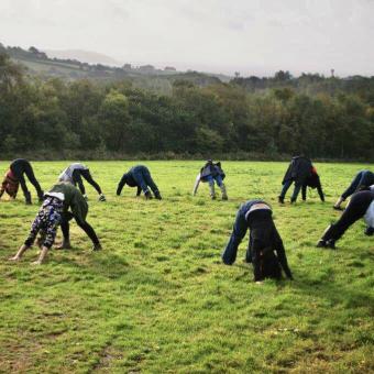 People doing yoga in a field